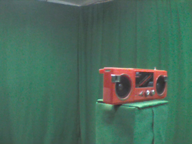 315 Degrees _ Picture 9 _ Red radio with speakers.png